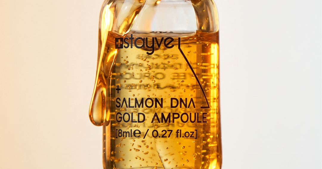 Close up of a Stayve Salmon DNA Gold PDRN ampoule bottle showing the golden serum and product label