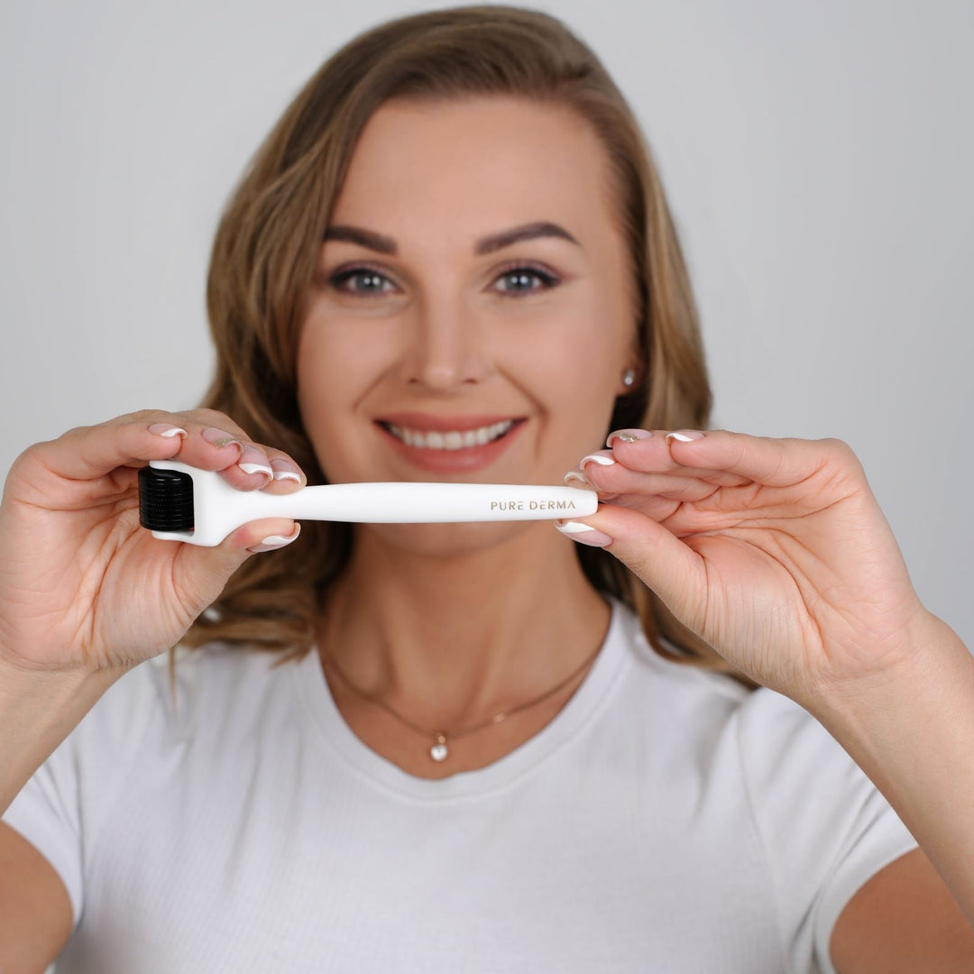 Woman holding a derma roller before her at-home skincare routine