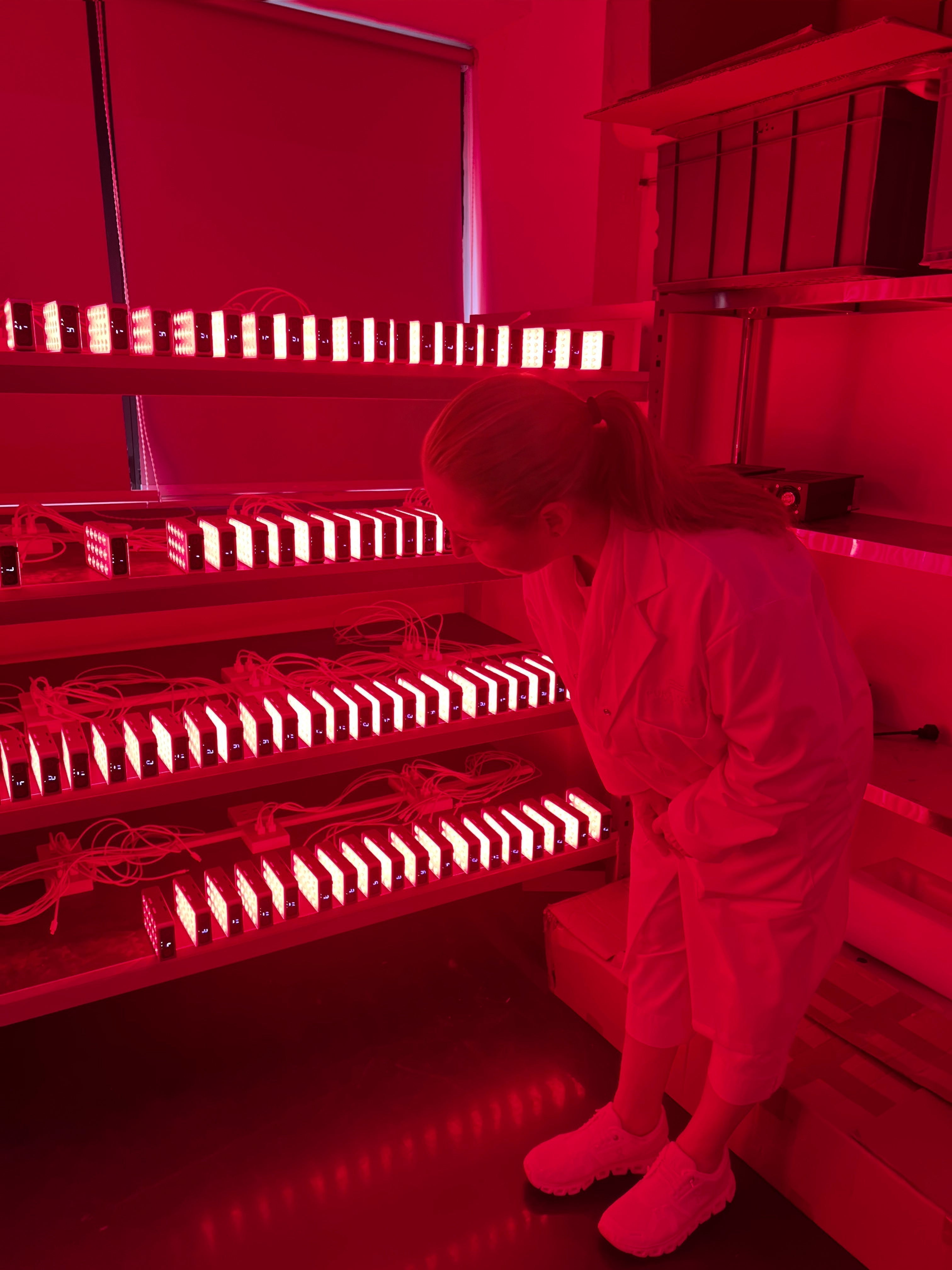 Owner of Pure Derma inspecting LED devices