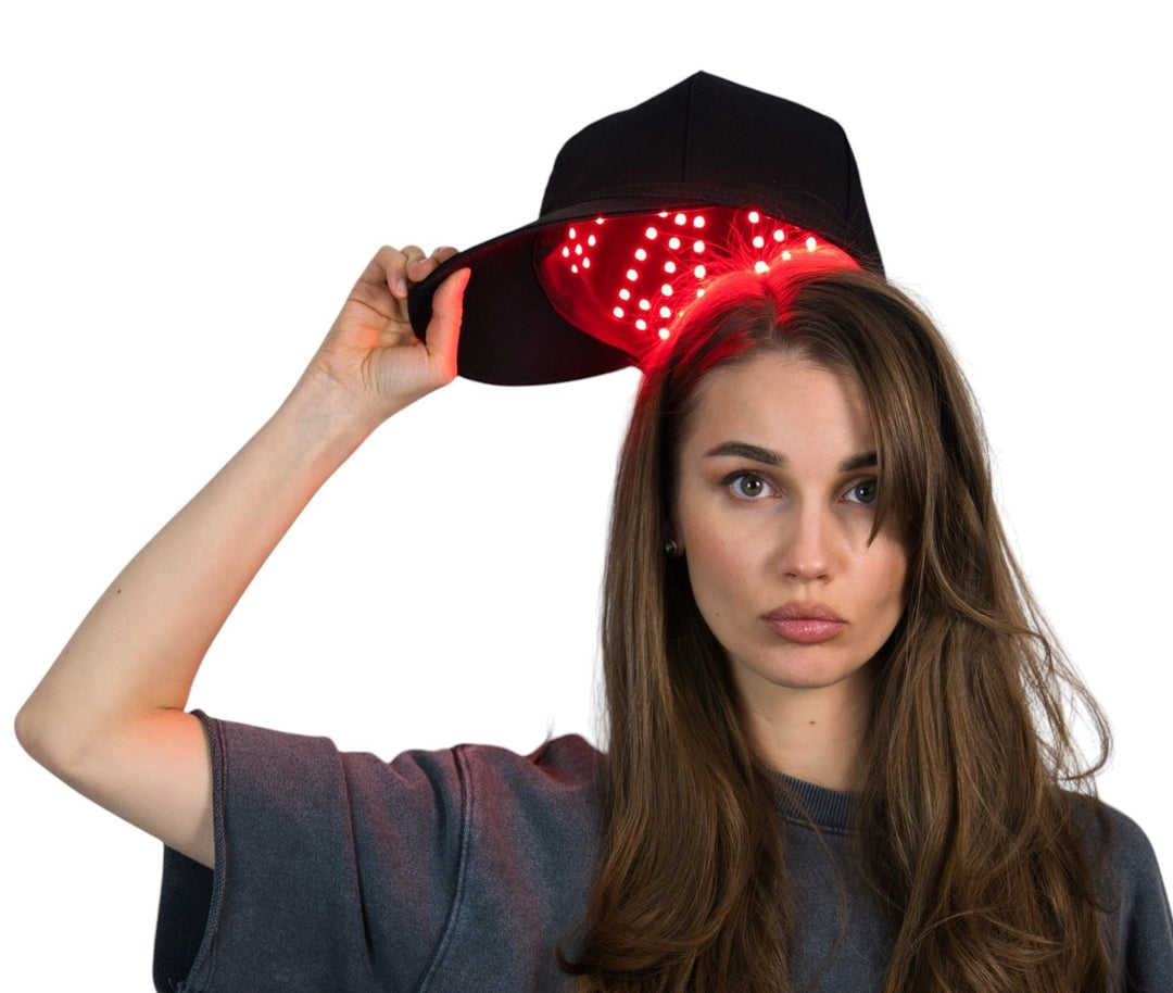 Woman wearing an LED hair growth cap during an at-home hair care routine