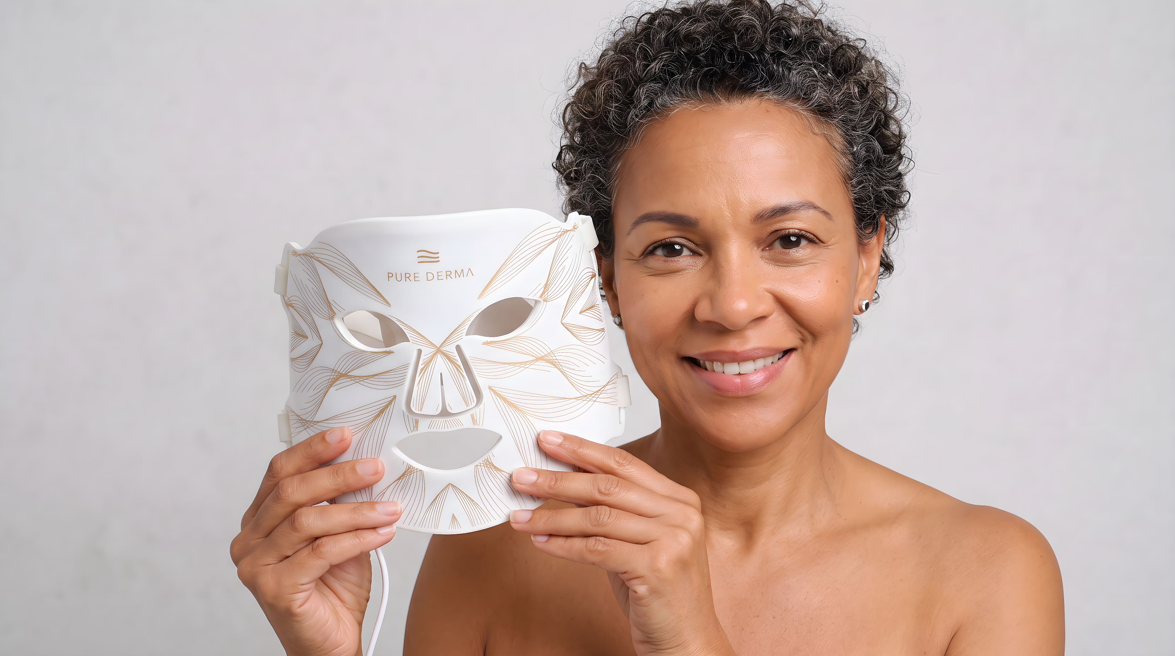 Woman holding a Pure Derma London LED Face Mask