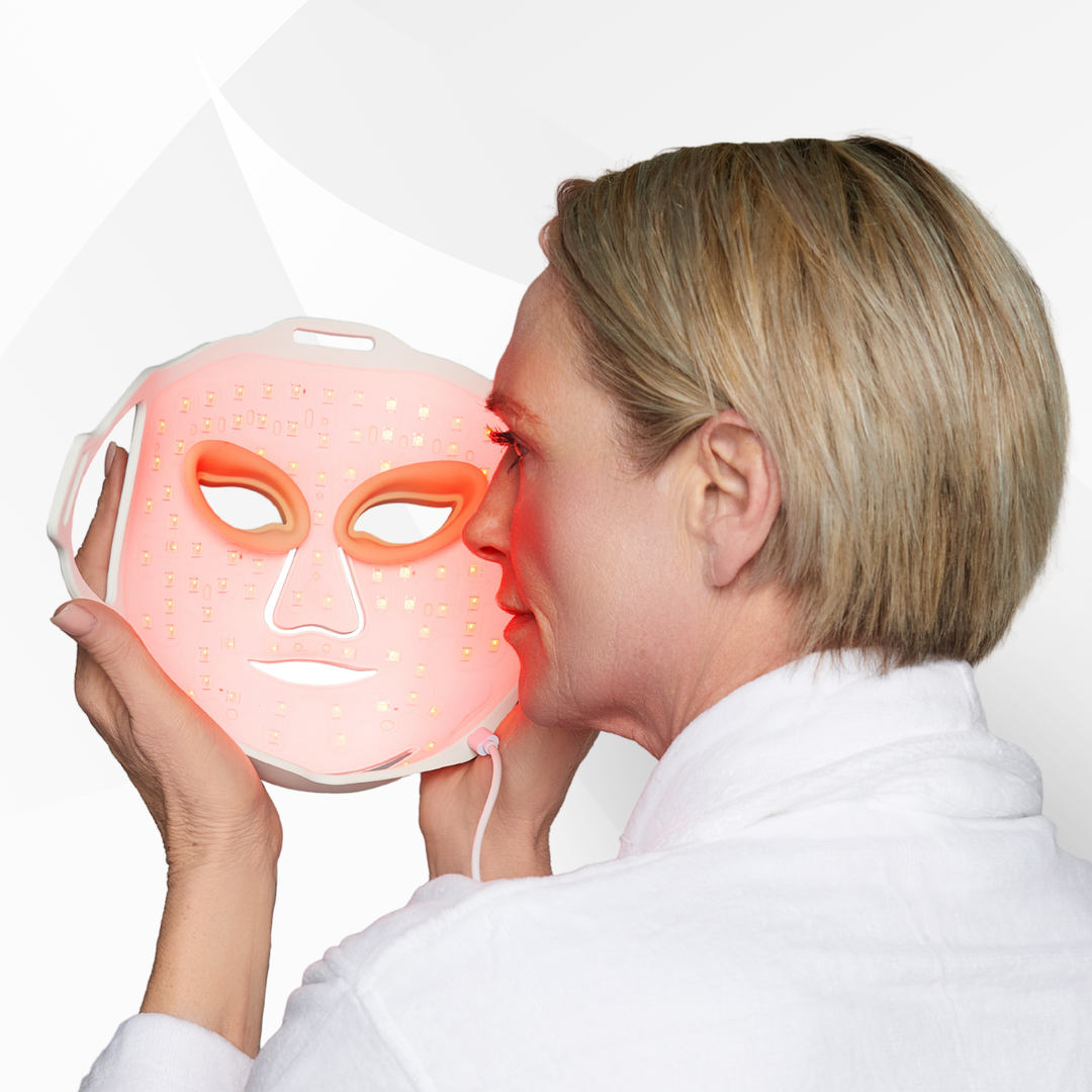 Person using a LED face mask with red light