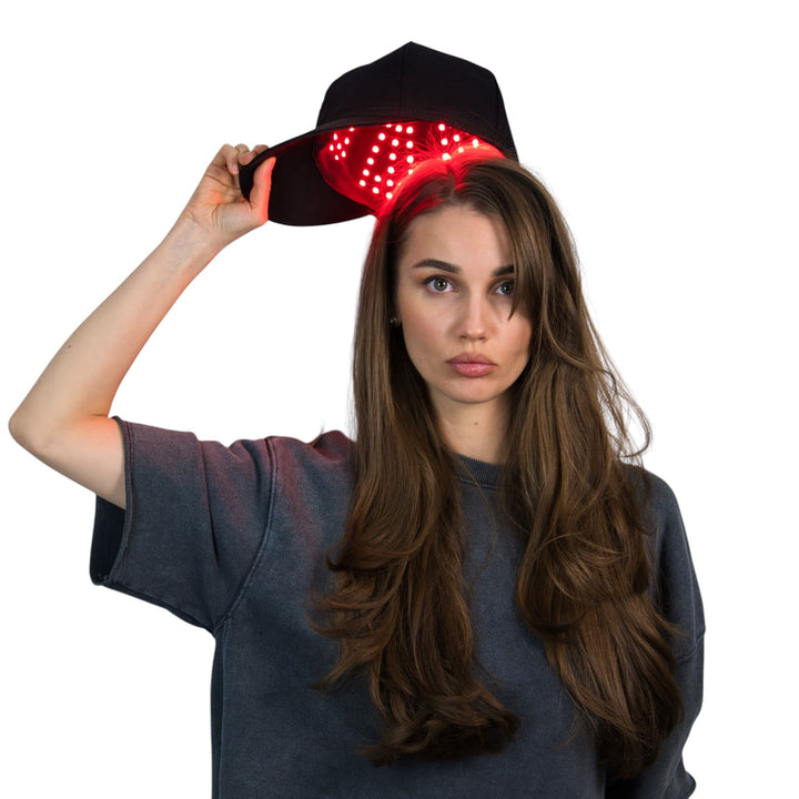 female model wearing Pure Derma London LED red light hair growth cap