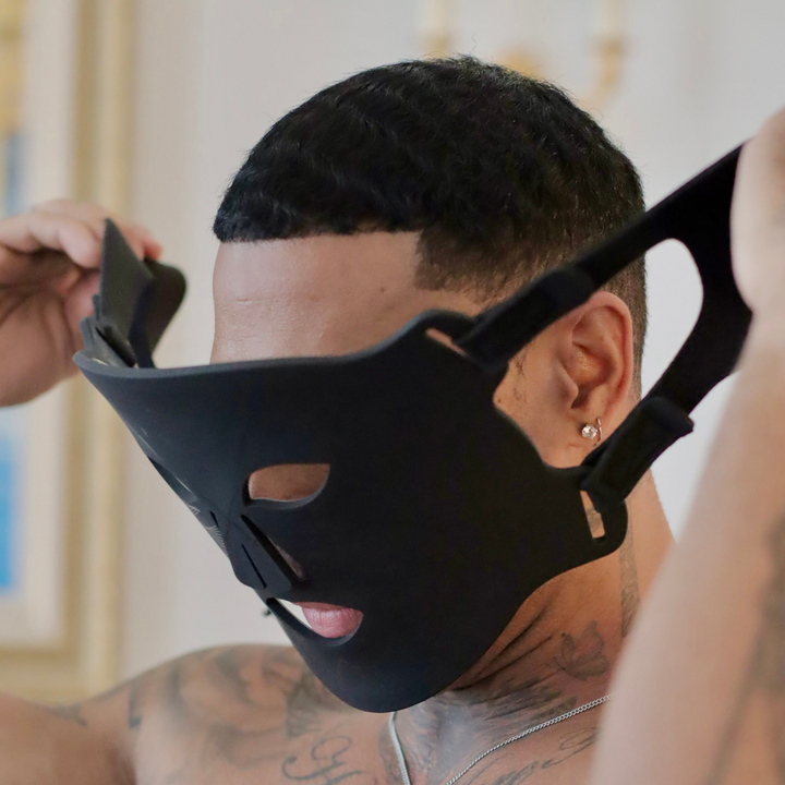 model showing head straps on men's black LED light therapy face mask